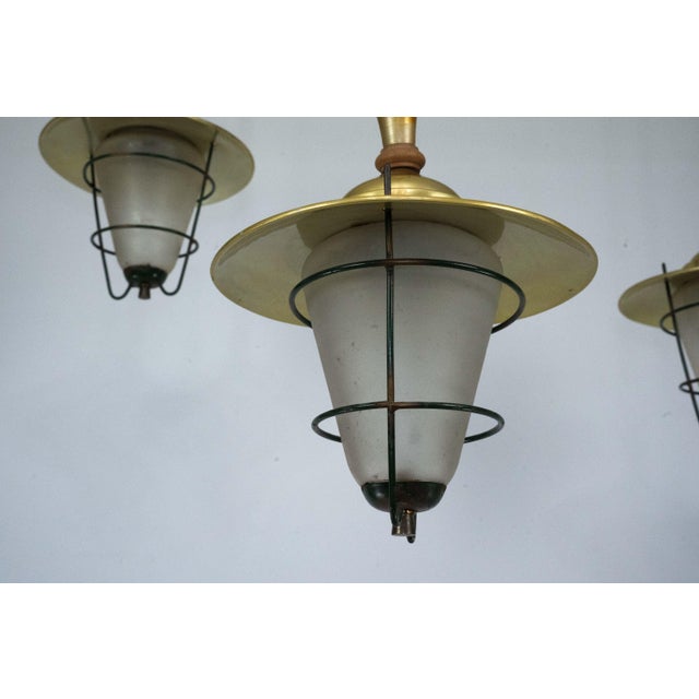 Elegant set of three Mid-Century hanging lanterns made in Italy during the 1960s. Featuring a refined combination of...