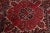 This is a stunning vintage Persian Heriz rug, artfully handcrafted using wool and featuring a vibrant red color field. The...