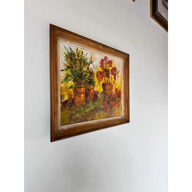 This vibrant vintage oil painting by B. Spencer captures the essence of blooming potted plants in a bold and textured...