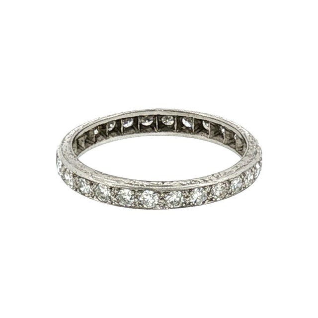 A 1920s platinum diamond wedding ring. This piece features 28 single-cut white diamonds with a total carat weight of 0.75....