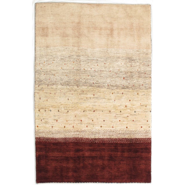 Vintage hand-knotted Persian Lori Gabbeh wool rug with a camel field featuring subtle horizontal tonal variation and...