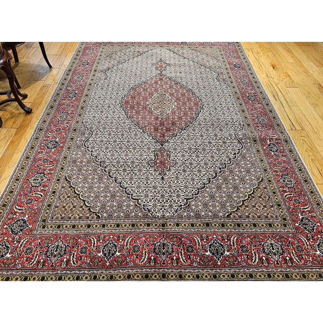 Discover a true masterpiece of Persian weaving with this magnificent Mid-20th Century Vintage Persian Tabriz "Mahi" Room-...