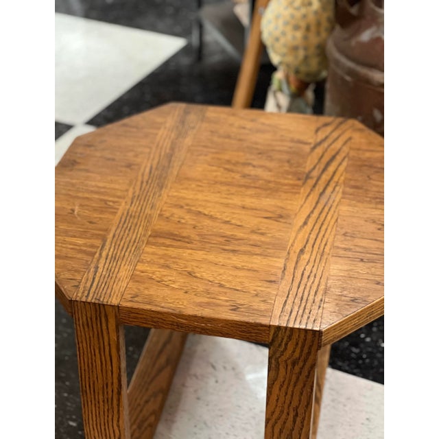 This structural accent table has a golden oak tone with an interesting detail of how the legs are insetted. Lovely grain...
