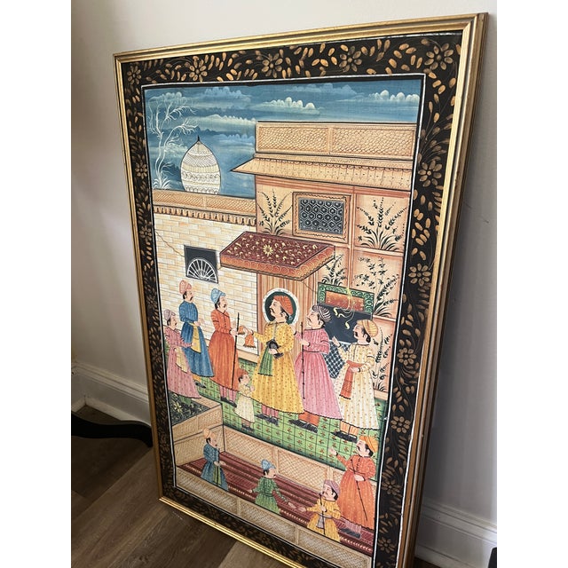 The painting depicts an elegant royal court scene, with a noble figure seated beneath a decorated pavilion while...