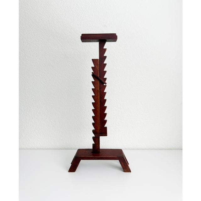 A large-scale, primitive style wooden ratchet candle stand, handmade in the 1990s. The distinctive zig-zag notches running...