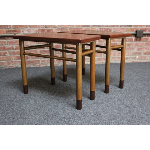 Pair of Edward Wormley for Dunbar walnut wedge/trapezium-form end tables with mahogany stretchers/bases and leather-...