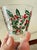 A charming vintage West Virginia Glass Company holiday barware set in the classic Holly pattern, featuring one large...
