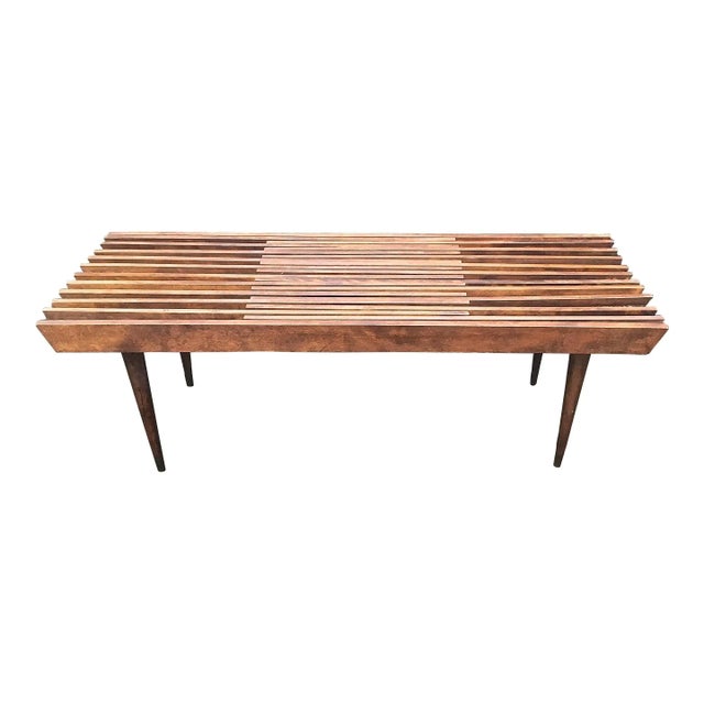 In the style of George Nelson, Mid-Century Modern, adjustable, slated bench with tapered legs. Each half of the bench is...
