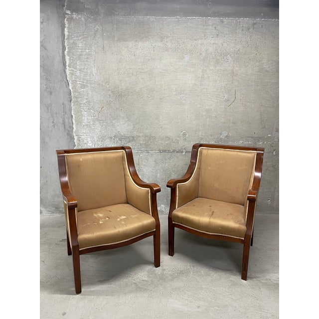An impressive and beautifully designed pair of vintage Swedish neoclassical style armchairs. The timeless frames are...