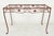 Reclaimed vintage painted wrought iron table base in a rectangular shape with decorative scrollwork and stylized leaves....