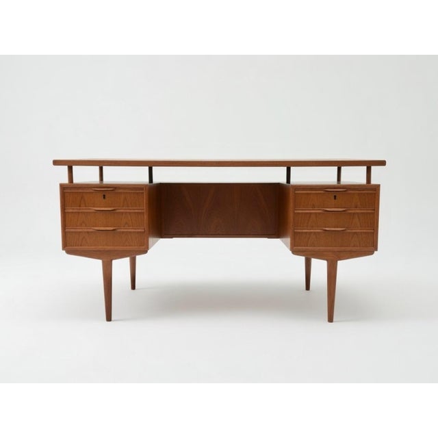1960s Danish Teak Executive Desk Beautiful Danish teak executive desk from the 1960s. The desk features a floating top...