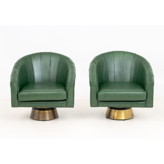 Pair of Borgade Green Leather Swivel Tub Chairs, on circular brass bases. 30" H x 30" W x 31" D; seat: 16" H. Provenance:...