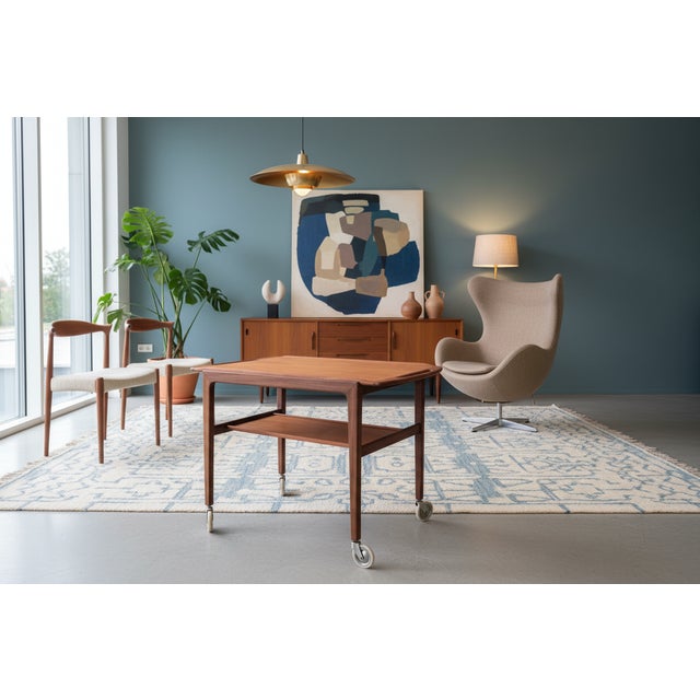 A very elegant Danish teak serving trolley with a softly rounded design and beautifully crafted details. The timeless...