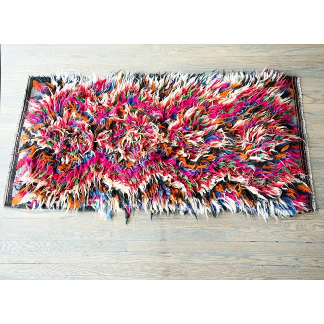 A striking mid-20th century Persian tulu rug with a fabulous shaggy wool diamond pattern woven in brilliant pinks,...