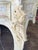 Carved figures on the corners, and cabriole legs. The base is cream, and the marble is white with gray veining.