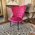 A dramatic vintage magenta velvet slipper chair with a wingback silhouette, low seat height, and sculptural profile suited...