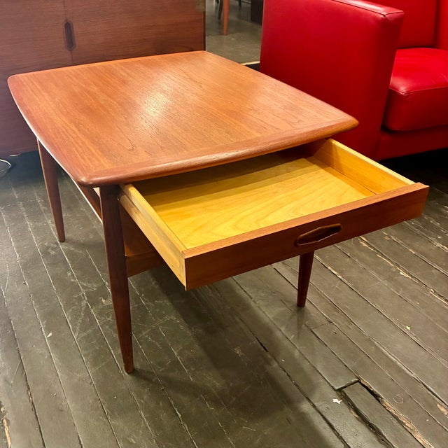 Teak Side Table with long Drawer from Denmark with solid tapered teak legs and shelf. Unmarked. In excellent condition, it...