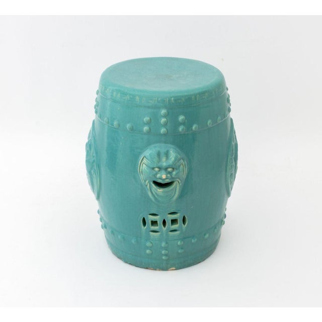 Chinese Turquoise Glazed Ceramic Garden Seat, with molded foo lion masques. 18" H x 14" Diameter. Provenance: From a...
