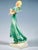 Finest viennese ceramic art from the 1930s: striding blonde girl in a green dress with softly falling shoulder pieces,...