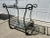 Vintage Cast and Wrought Iron 2 Tier Bar Cart With Beveled Glass Tops. Cart has push bar handles on both sides to push...
