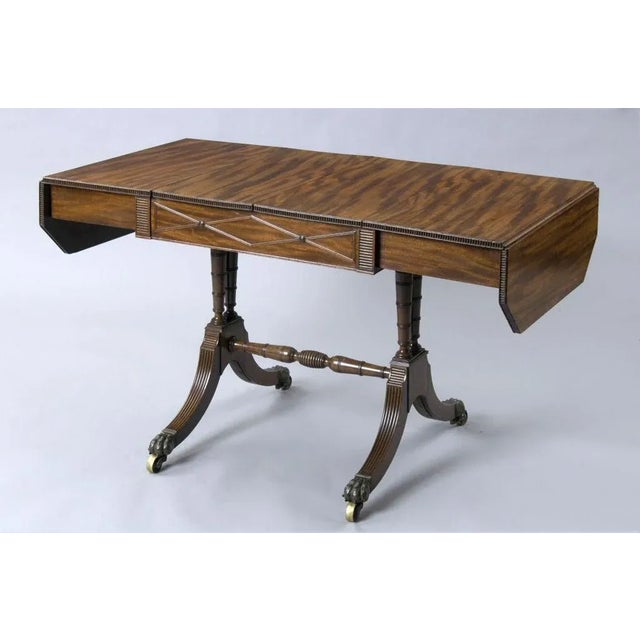 Most unusual, elegant and very fine Regency period mahogany sofa games table with carved reeding around top edge and...