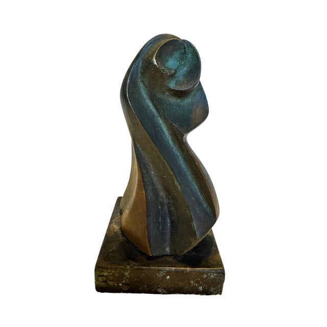 A striking mid-century modern abstract bronze sculpture depicting a graceful draped female figure in a minimalist, flowing...
