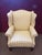 This wingback chair is upholstered with a striped tan and beige linen. It features a removable seat cushion for easy...