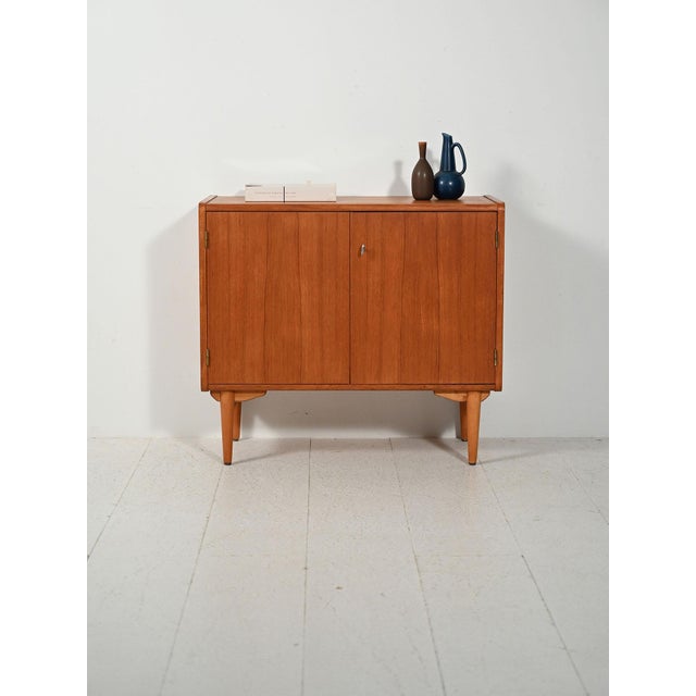 Scandinavian teak and oak cabinet from the 1960s, produced by Sonett (Tenhult), with hinged doors and an adjustable...