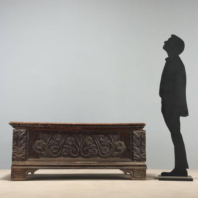 18th-century walnut chest from Italy, featuring a dentil moulding under the top. The front panel is enriched with vine...