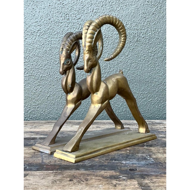 These striking vintage brass bookends are a masterful expression of Mid-Century Modern design, featuring a pair of...