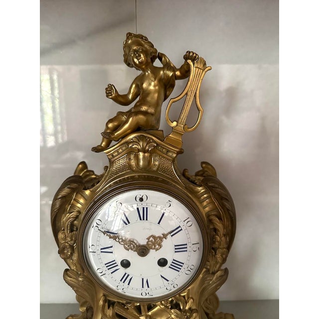 19th Century French Louis XVI Ormolu Bronze Mantel Clock with Winged Putti and Enamel Dial Bring home a masterpiece of...