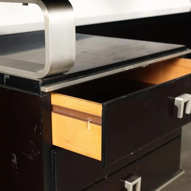 Desk of large dimensions with columns, side drawers in stained exotic wood veneer and chromed aluminium. This piece is...