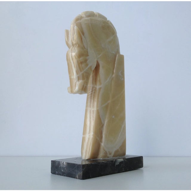 A vintage Mid-Century tall marble carved trojan horse mounted on a black marble rectangular base. As is found condition,...