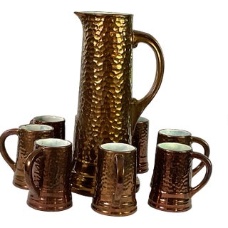 1930s Handcrafted, Artisan – Ceramic Large, Pitcher, and Eight Tankards-in a Hammered Copper Lusterware Finish - Set of 9 For Sale
