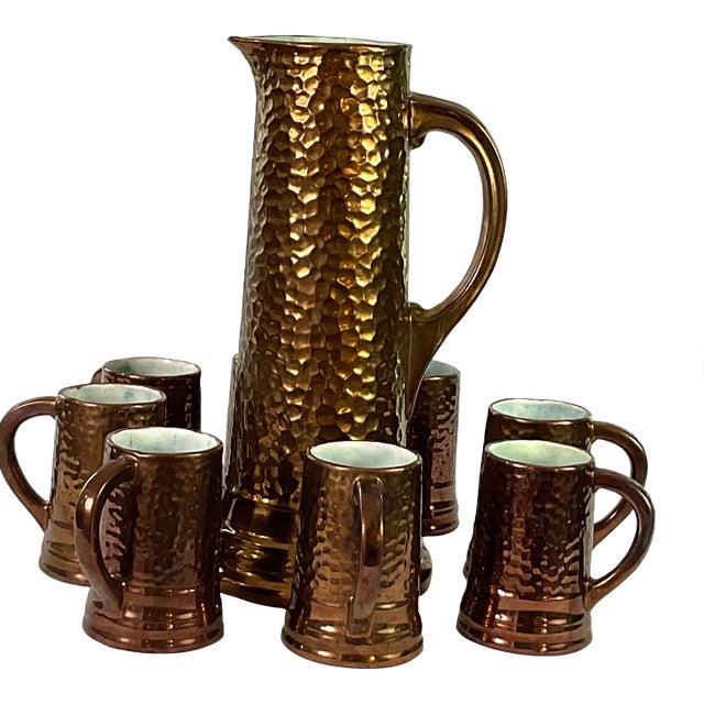 1930s Handcrafted, Artisan – Ceramic Large, Pitcher, and Eight Tankards-in a Hammered Copper Lusterware Finish - Set of 9 For Sale