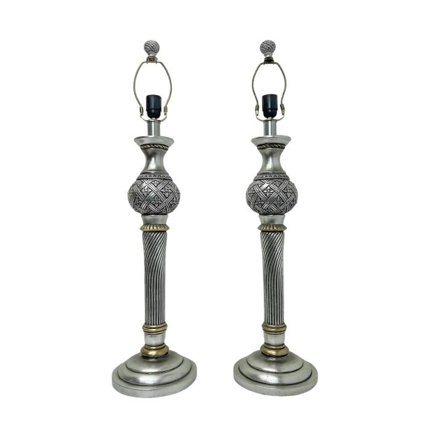 A set of very elegant tall table lamps, with beautiful carvings and silver and gold finishes. They are made of composite,...