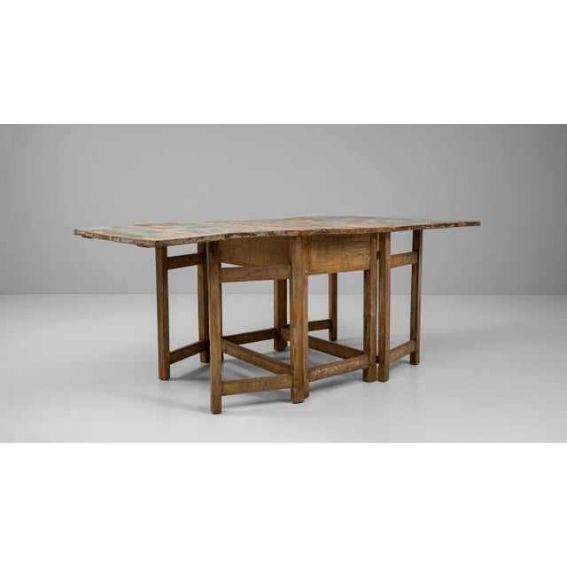 This 19th Century Swedish drop-leaf table is a charming example of functional rustic design with timeless appeal. Crafted...