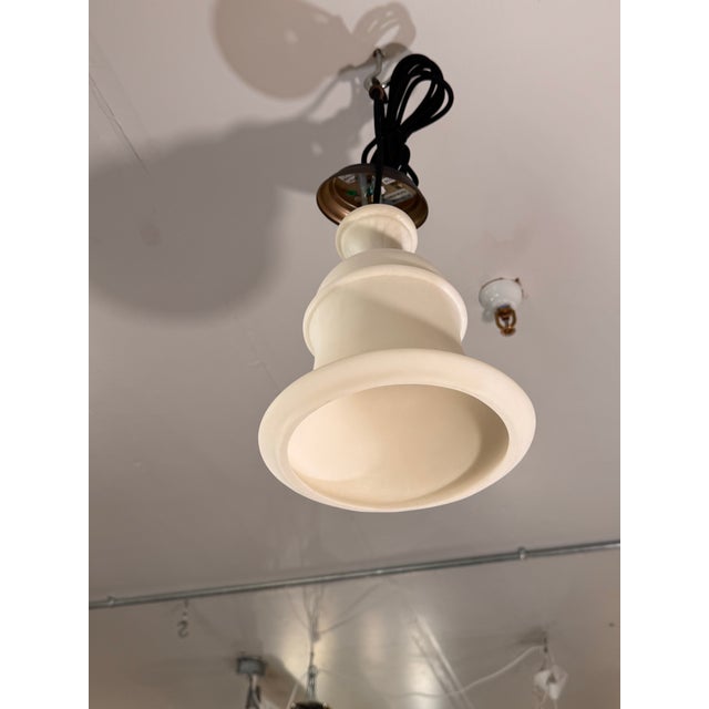 Design Plus Gallery presents a Noah Bell Pendant Light from Pottery Barn. This pendant showcases a faux stone bell shade...