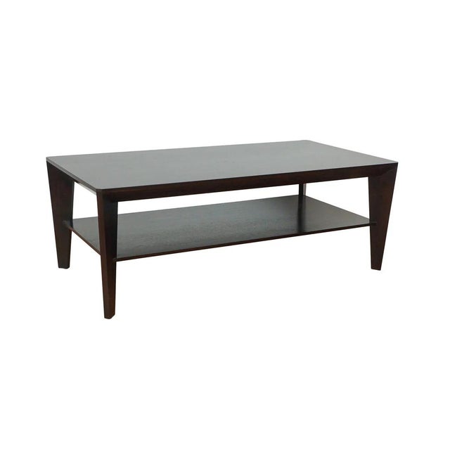 Chic coffee table with multi-sided diagonal base and a shelf. Shown in ebonized walnut. width: 47" depth: 24" height: 16.5"