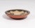 A pottery bowl by the Santo Domingo potter Hilda Coriz. Signed to the underside, this shallow bowl has a stylized bird...
