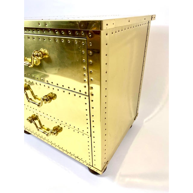 Mid century Sarreid 3 drawer chest/side table with wooden bun feet, and brass handles. In original found condition. It...