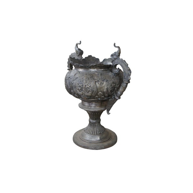 A large 20th century antiqued Indian bronze footed floor urn or planter. Features figural elephants over Phoenix / Griffin...