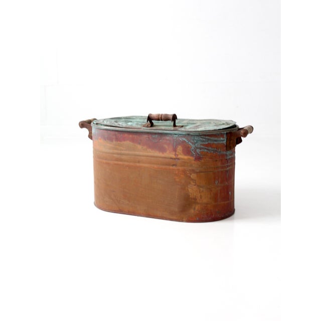 A beautifully aged late 19th-century copper wash boiler featuring a richly patinated surface with verdigris accents,...