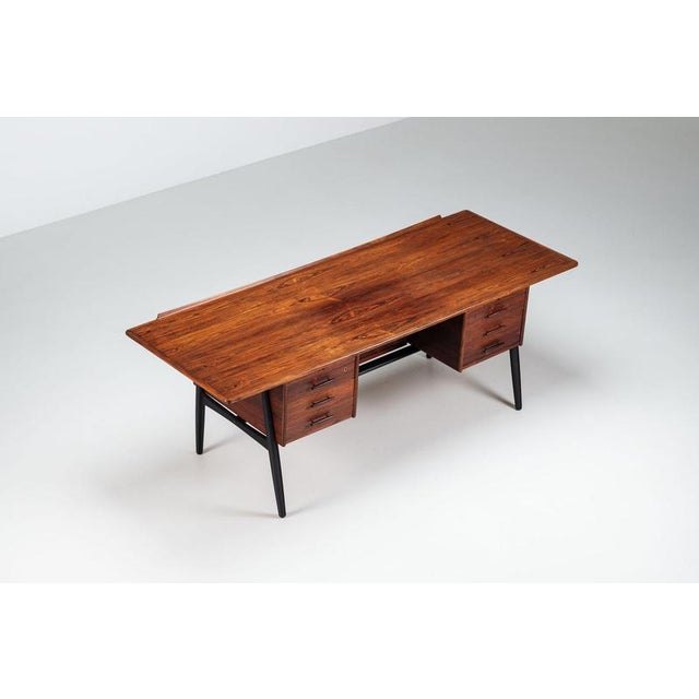 Scandinavian executive desk in rosewood with integrated bar, Denmark, 1960. A striking freestanding desk that perfectly...