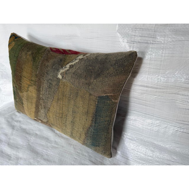 Antique 17th century Brussels verdure tapestry pillow featuring a genuine Flemish textile fragment with a uniquely aged...