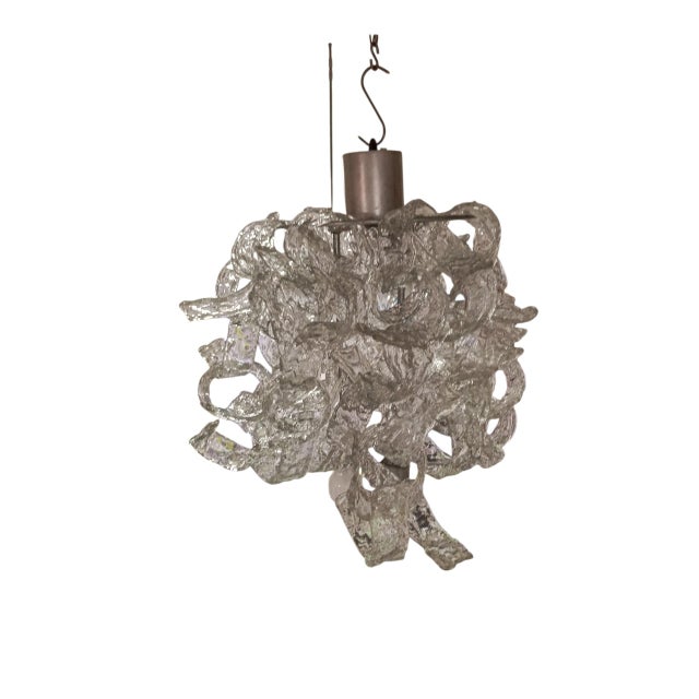 1970s 3-light chandelier with metal frame and clear glass spiral-shaped pendants. the chandelier has a lamp holder that...