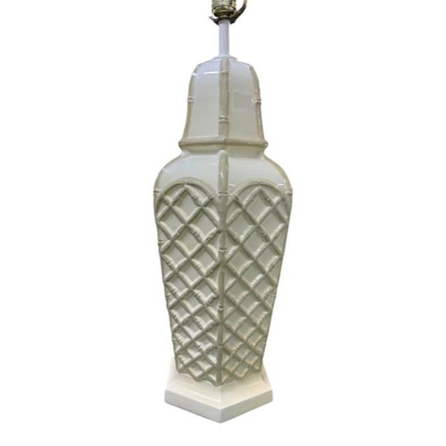 Elegant vintage pair of faux bamboo glazed ceramic table lamps in a classic Palm Beach Regency style. Featuring an...