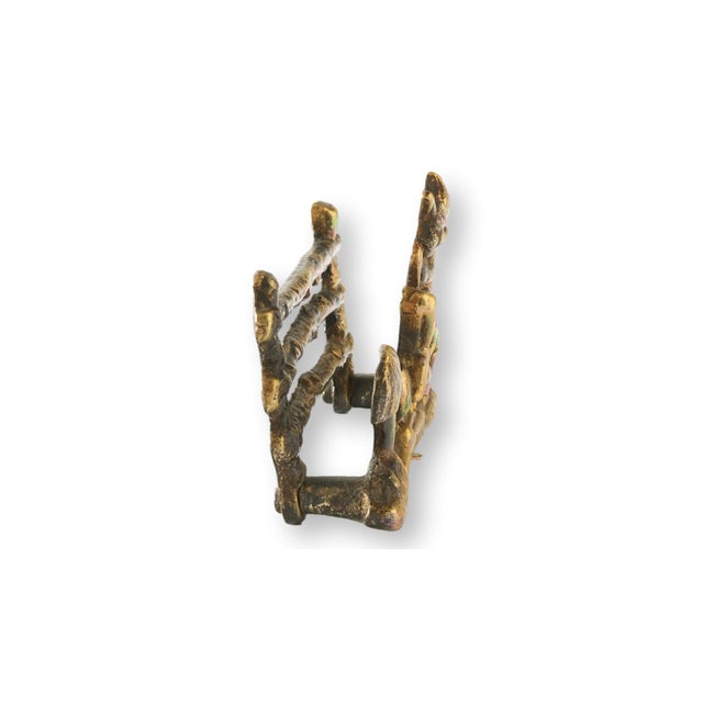 Early 20th century English brass letter rack featuring a mischievous imp figure seated among stylized fence rails and...