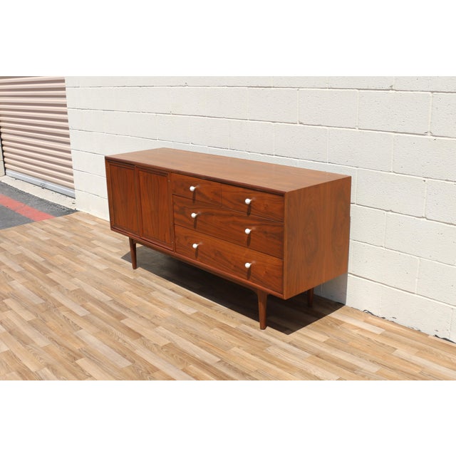 An exceptional Mid-Century Modern walnut dresser designed by the celebrated duo Kipp Stewart and Stewart MacDougall for...