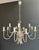 This beautiful and elegant neoclassical-style chandelier is made of silver-plated metal. It is a French work from Maison...